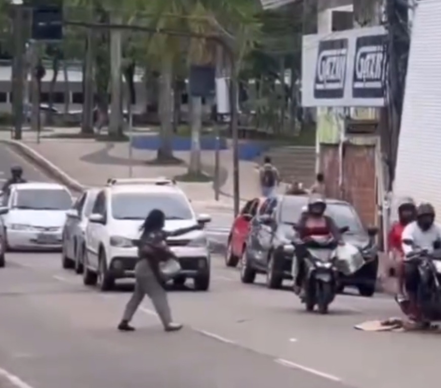 Moradora de rua tenta atingir veículos com pedaço de madeira e por pouco não é atropelada; veja o vídeo